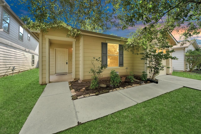 12047 Madison Oak St, Houston, TX 77038 - view of front facade featuring a lawn, a garage, and driveway