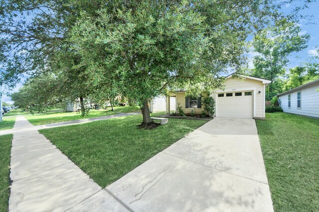 12047 Madison Oak St, Houston, TX 77038 - view of front facade featuring driveway, an attached garage, and a front yard
