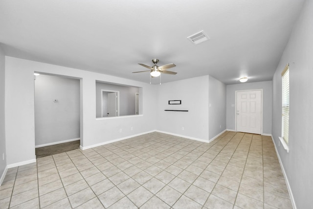 12047 Madison Oak St, Houston, TX 77038 - spare room featuring a ceiling fan, light tile patterned floors, and baseboards