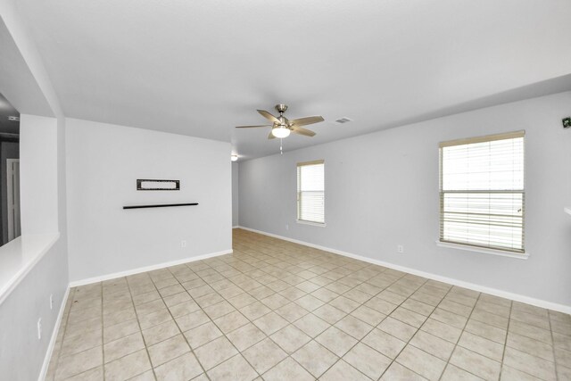 12047 Madison Oak St, Houston, TX 77038 - spare room with a ceiling fan, baseboards, and light tile patterned flooring