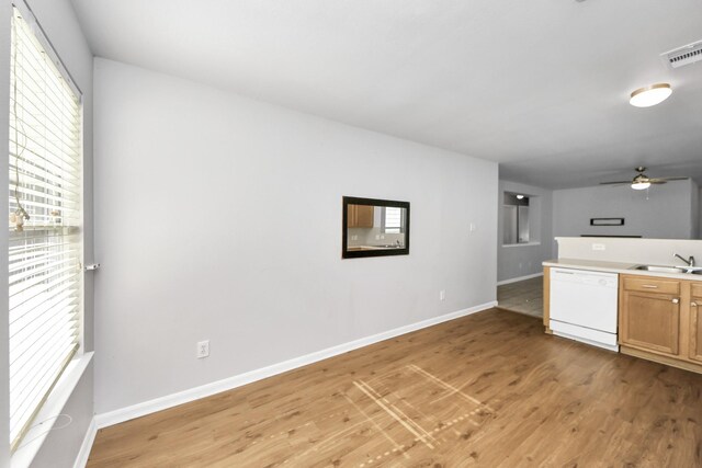 12047 Madison Oak St, Houston, TX 77038 - kitchen featuring white dishwasher, plenty of natural light, light wood finished floors, and a sink