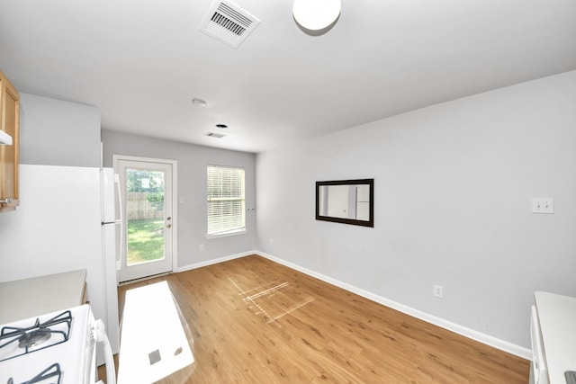 12047 Madison Oak St, Houston, TX 77038 - unfurnished dining area with light wood-type flooring and baseboards