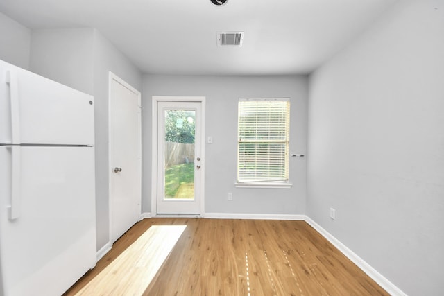 12047 Madison Oak St, Houston, TX 77038 - doorway to outside featuring wood finished floors and baseboards
