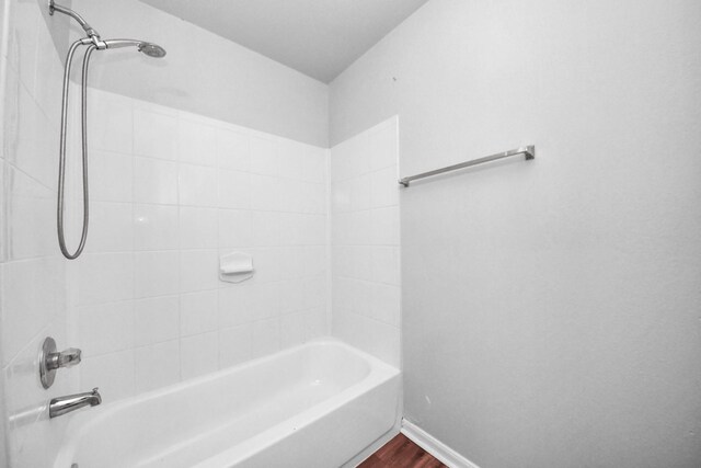 12047 Madison Oak St, Houston, TX 77038 - full bathroom with tub / shower combination, wood finished floors, and baseboards