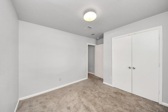 12047 Madison Oak St, Houston, TX 77038 - unfurnished bedroom featuring carpet, baseboards, and a closet