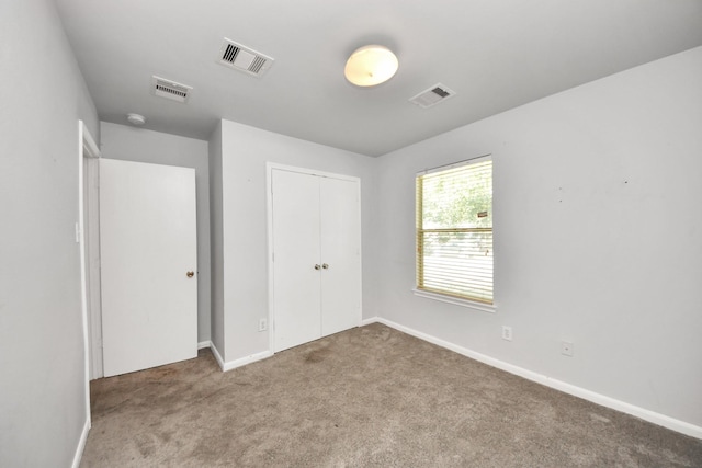 12047 Madison Oak St, Houston, TX 77038 - unfurnished bedroom with carpet flooring, a closet, and baseboards