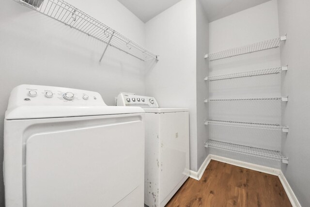 12047 Madison Oak St, Houston, TX 77038 - washroom featuring baseboards, washing machine and clothes dryer, and wood finished floors