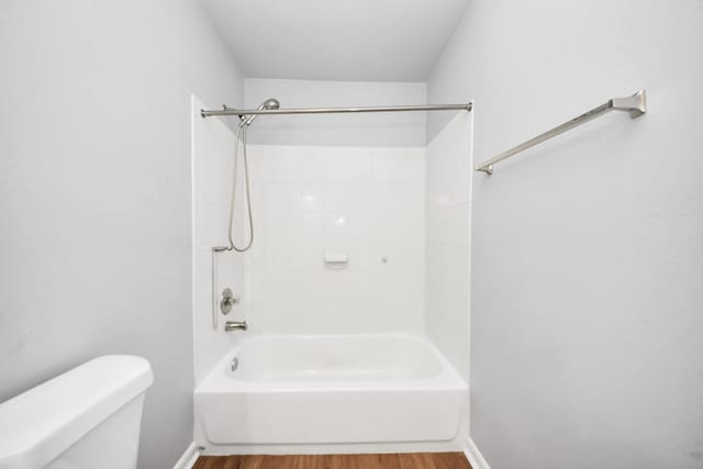 12047 Madison Oak St, Houston, TX 77038 - bathroom with toilet, wood finished floors, bathing tub / shower combination, and baseboards