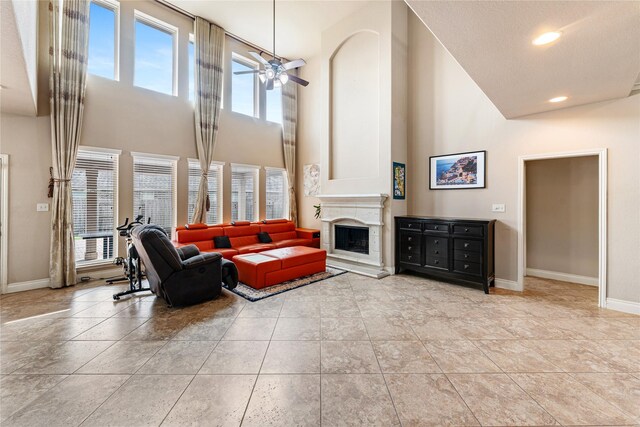 10827 Naburn Gate, Richmond, TX 77407 - living room with a high ceiling, plenty of natural light, baseboards, a fireplace with raised hearth, and recessed lighting