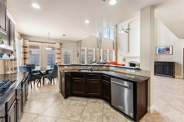 10827 Naburn Gate, Richmond, TX 77407 - kitchen with dishwasher, a sink, dark brown cabinets, dark stone countertops, and black gas cooktop