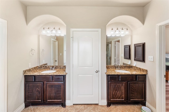 10827 Naburn Gate, Richmond, TX 77407 - bathroom with two vanities, a shower, and baseboards