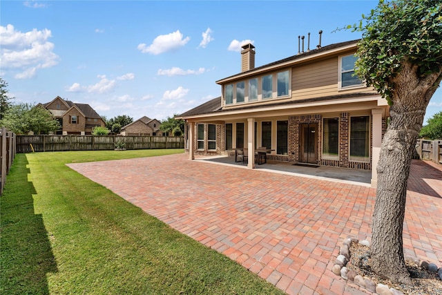 10827 Naburn Gate, Richmond, TX 77407 - rear view of property featuring a patio area, brick siding, and a chimney
