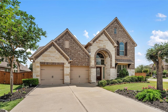 10827 Naburn Gate, Richmond, TX 77407 - french country inspired facade featuring stone siding, concrete driveway, a garage, and brick siding