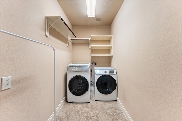 10827 Naburn Gate, Richmond, TX 77407 - washroom featuring separate washer and dryer and baseboards