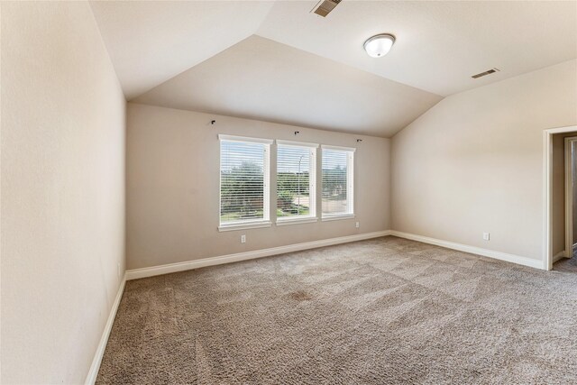 10827 Naburn Gate, Richmond, TX 77407 - carpeted spare room featuring vaulted ceiling and baseboards