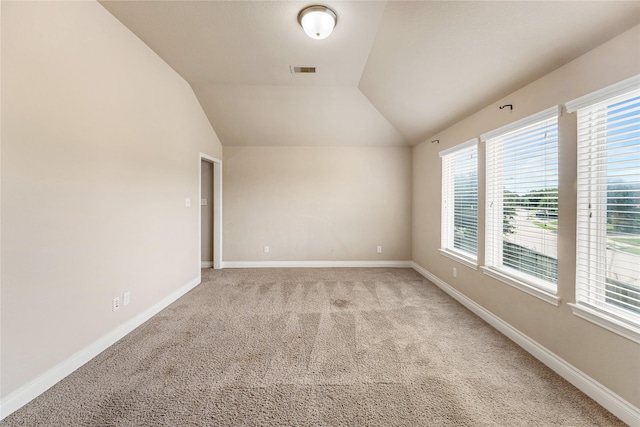 10827 Naburn Gate, Richmond, TX 77407 - spare room featuring light colored carpet, baseboards, and vaulted ceiling