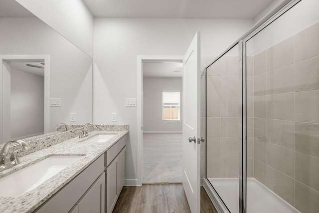 752 Westpointe Dr, Dayton, TX 77535 - full bathroom with wood finished floors, double vanity, and baseboards