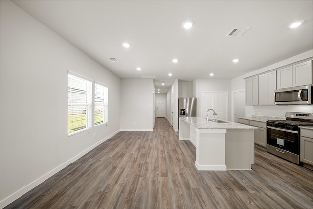 752 Westpointe Dr, Dayton, TX 77535 - kitchen featuring appliances with stainless steel finishes, wood finished floors, baseboards, a sink, and recessed lighting