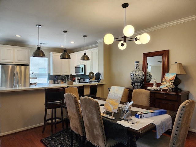 2722 Crawford St, Houston, TX 77004 - dining space with crown molding, dark wood finished floors, a chandelier, baseboards, and recessed lighting
