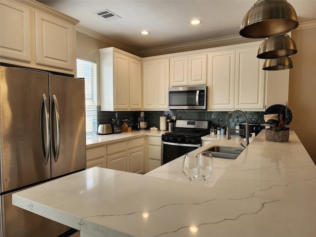 2722 Crawford St, Houston, TX 77004 - kitchen with stainless steel appliances, ornamental molding, tasteful backsplash, light stone countertops, and a sink