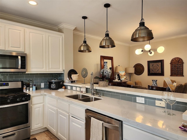 2722 Crawford St, Houston, TX 77004 - kitchen with appliances with stainless steel finishes, a sink, crown molding, decorative backsplash, and white cabinetry