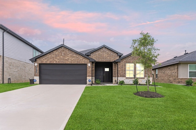 30114 Ousel Falls Ln, Fulshear, TX 77494 - view of front of home featuring an attached garage, concrete driveway, a lawn, brick siding, and stone siding