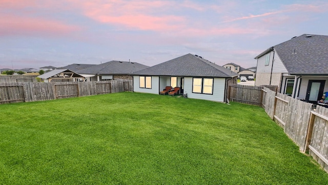 30114 Ousel Falls Ln, Fulshear, TX 77494 - back of property at dusk featuring a shingled roof