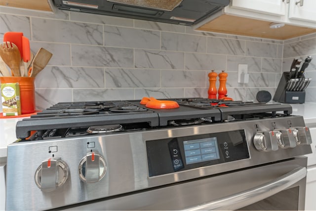 30114 Ousel Falls Ln, Fulshear, TX 77494 - kitchen view of gas stove, ventilation hood, and backsplash