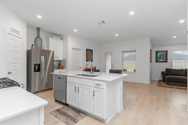 30114 Ousel Falls Ln, Fulshear, TX 77494 - kitchen featuring a sink, stainless steel appliances, light wood-style flooring, light countertops, and recessed lighting