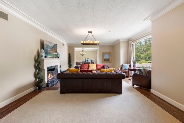 1403 N Thompson St, Conroe, TX 77301 - living area with wood finished floors, a chandelier, ornamental molding, a premium fireplace, and baseboards