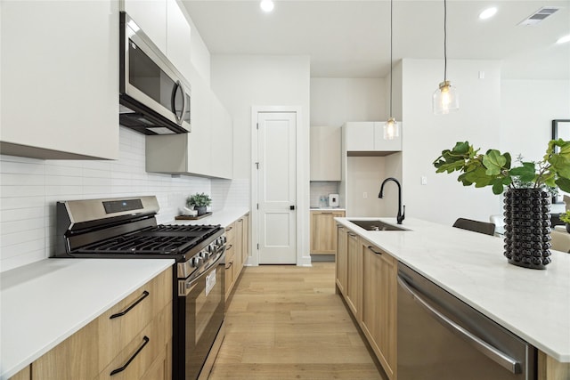3907D Tulane St, Houston, TX 77018 - kitchen with appliances with stainless steel finishes, a sink, light wood finished floors, tasteful backsplash, and modern cabinets