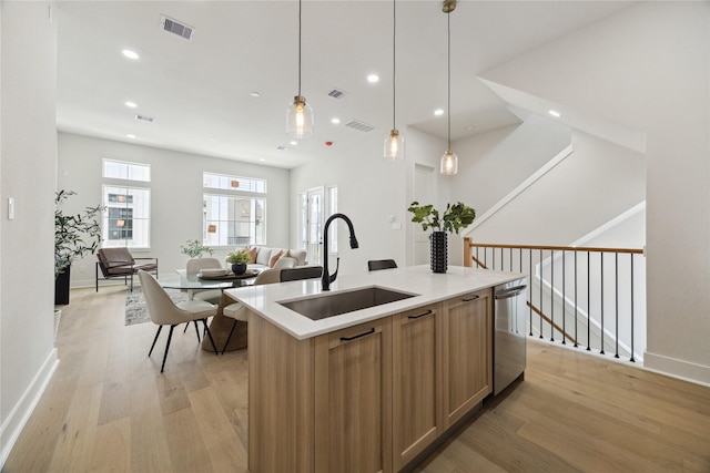 3907D Tulane St, Houston, TX 77018 - kitchen featuring a sink, stainless steel dishwasher, light wood finished floors, open floor plan, and light countertops