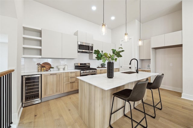 3907D Tulane St, Houston, TX 77018 - kitchen with beverage cooler, stainless steel appliances, open shelves, a sink, and light wood-style floors