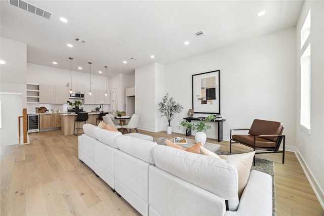 3907D Tulane St, Houston, TX 77018 - living room with wine cooler, light wood-type flooring, recessed lighting, and baseboards