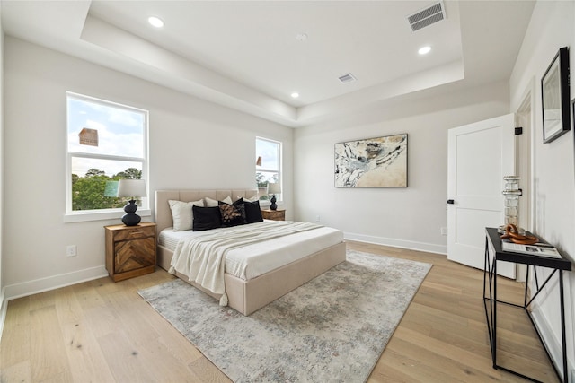3907D Tulane St, Houston, TX 77018 - bedroom featuring a tray ceiling, light wood-style floors, baseboards, and recessed lighting