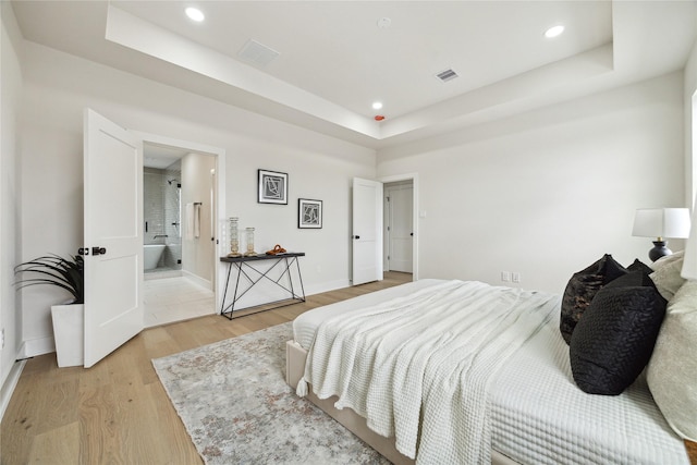 3907D Tulane St, Houston, TX 77018 - bedroom featuring a raised ceiling, recessed lighting, light wood-style flooring, and baseboards