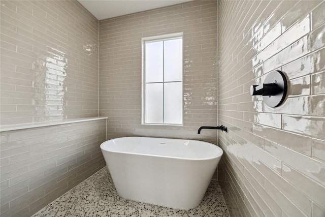 3907D Tulane St, Houston, TX 77018 - bathroom featuring tile walls, a freestanding bath, and speckle patterned floor