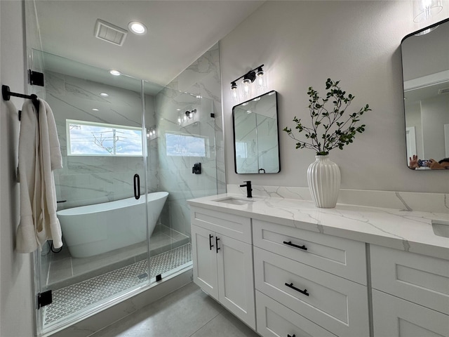1803 Brooks St, Houston, TX 77026 - full bath featuring double vanity, a freestanding bath, a shower stall, and recessed lighting