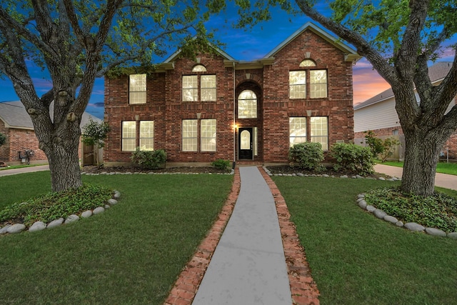 1605 Spring Glen Ln, Pearland, TX 77581 - traditional-style house featuring a front lawn and brick siding