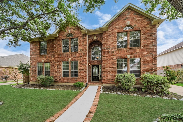 1605 Spring Glen Ln, Pearland, TX 77581 - view of front facade with brick siding and a front yard