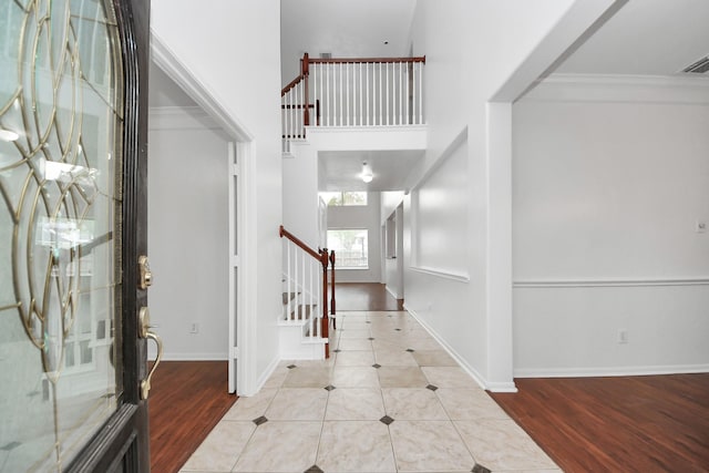 1605 Spring Glen Ln, Pearland, TX 77581 - entryway with stairs, wood finished floors, baseboards, and ornamental molding
