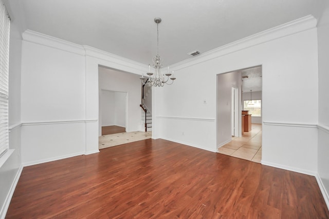 1605 Spring Glen Ln, Pearland, TX 77581 - empty room with a chandelier, crown molding, stairs, wood finished floors, and baseboards