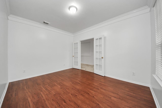 1605 Spring Glen Ln, Pearland, TX 77581 - unfurnished bedroom featuring french doors, crown molding, wood finished floors, and baseboards