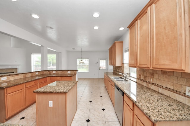 1605 Spring Glen Ln, Pearland, TX 77581 - kitchen featuring stainless steel dishwasher, a kitchen island, tasteful backsplash, recessed lighting, and a sink