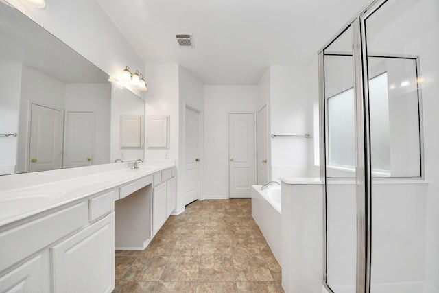 1605 Spring Glen Ln, Pearland, TX 77581 - bathroom with double vanity, a garden tub, a shower stall, and stone finish flooring