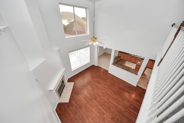 1605 Spring Glen Ln, Pearland, TX 77581 - foyer featuring a high ceiling, dark wood-style flooring, a tiled fireplace, and ceiling fan