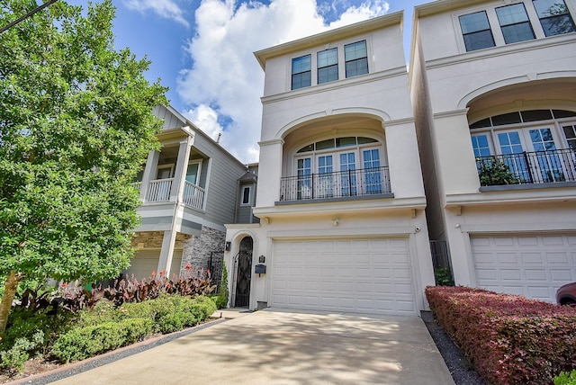 4220 Law St, Houston, TX 77005 - townhome / multi-family property featuring an attached garage, stucco siding, and concrete driveway
