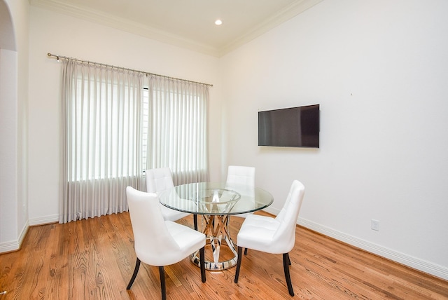 4220 Law St, Houston, TX 77005 - dining room with crown molding, wood finished floors, baseboards, and arched walkways
