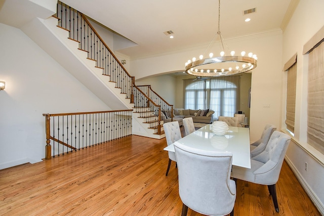 4220 Law St, Houston, TX 77005 - dining space featuring a chandelier, wood finished floors, stairway, ornamental molding, and baseboards