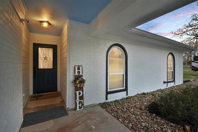4620 Springfield Ln, Brenham, TX 77833 - exterior entry at dusk with brick siding